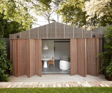 A modern timber-clad pool house which has been designed as a studio.