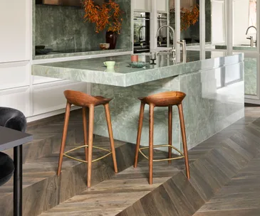 timber barstools at a green marble kitchen bench