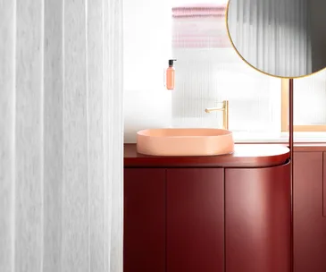 Bathroom featuring a custom-made red vanity
