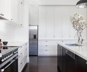 white kitchen with stainless steel fridge