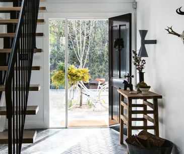 A country home entryway with dark timber flooring