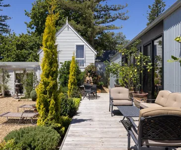 extended weatherboard home with outdoor courtyard and deck