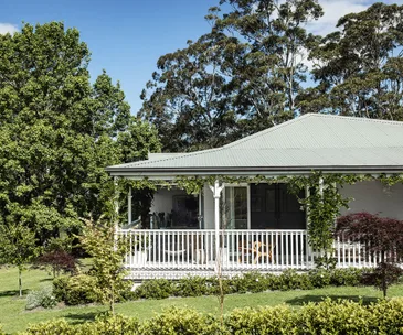 country home with a white vine covered verandah
