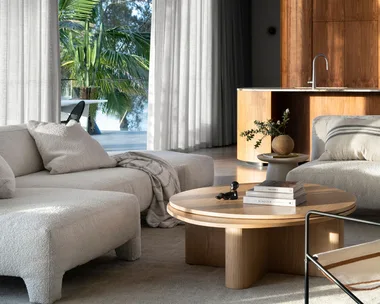 A contemporary living room showing a modern oak round coffee table