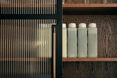 refillable bottles on a glass shelf