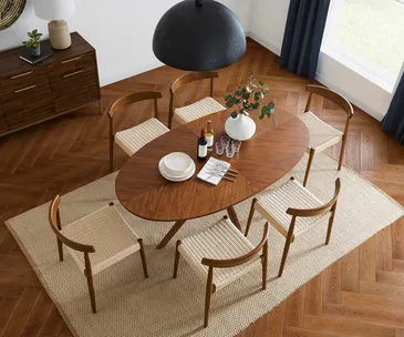 Castlery timber dining table on a beige rug