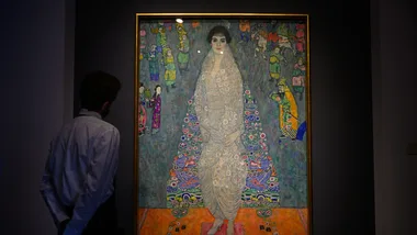 An art handler stands in front of Bildnis Elisabeth Lederer (Portrait of Elisabeth Lederer), by Gustav Klimt, during a press preview at Sotheby's before the auction making it one of the most expensive paintings on November 07, 2025 in New York City.