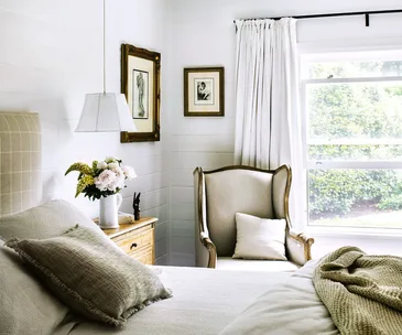 A country style bedroom with a green outlook