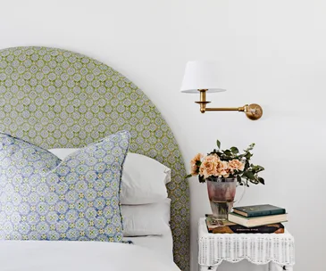 Pale blue and green Anna Spiro upholstery in a white bedroom