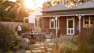 Homeowners Pip and Mal with their daughter Felicity in their layered and colourful garden