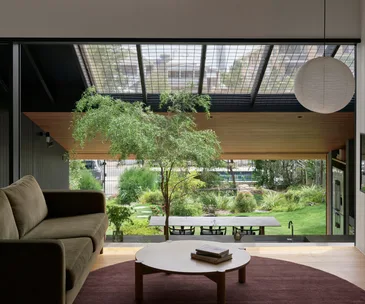A Japanese-inspired living space with a lantern pendant and indoor-outdoor connection