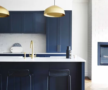 navy kitchen with gold tapware
