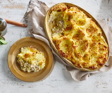 A cheese, potato and leek pie on a timber table