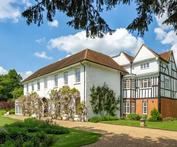 The wisteria covered facade of an historic English manor in Little Marlow, Buckinghamshire