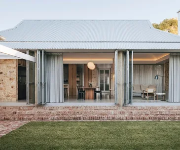 A renovated home in Rose Park sprawls out onto its lawn area through floor-to-ceiling bi-fold doors