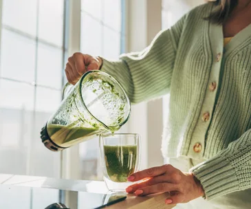 woman-pouring-green-juice